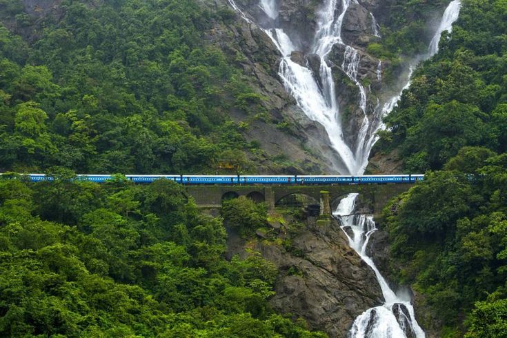 Goa tour package Dudhsagar Falls with cascading water and lush greenery